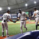 May 26, 2022; St. Petersburg, Florida, USA;  New York Yankees third baseman Marwin Gonzalez (14) and right fielder Aaron Judge (99) are congratulated by shortstop Isiah Kiner-Falefa (12) after scoring during the sixth inning against the Tampa Bay Rays at Tropicana Field. Mandatory Credit: Kim Klement-USA TODAY Sports