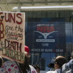 Protesters gather outside of the NRA's annual meeting in Houston.