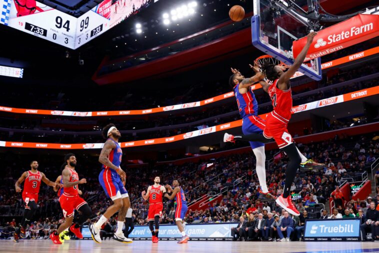 FILE PHOTO: Mar 9, 2022; Detroit, Michigan, USA;  Chicago Bulls guard Ayo Dosunmu (12) is fouled by Detroit Pistons forward Isaiah Livers (12) in the second half at Little Caesars Arena. Mandatory Credit: Rick Osentoski-USA TODAY Sports