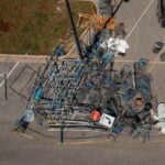 Workers clear debris from a Walmart store parking lot following a tornado in Round Rock, Texas, U.S., on Tuesday, March 22, 2022. There were 22 reports of tornadoes, mainly across eastern Texas, as well as one in Oklahoma, according to the Storm Prediction Center. Photographer: Jordan Vonderhaar/Bloomberg via Getty Images