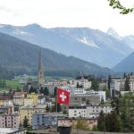 A Swiss national flag above the town ahead of the World Economic Forum (WEF) in Davos, Switzerland, on Saturday, May 21, 2022. The annual Davos gathering of political leaders, top executives and celebrities runs from May 22 to 26. Photographer: Hollie Adams/Bloomberg via Getty Images