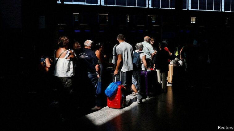 Passengers queue at check-in desks at Malaga-Costa del Sol Airport, in Malaga, Spain June 4, 2022. REUTERS/Jon Nazca