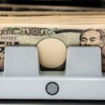 BoJ sticks to loose monetary policy sending yen sharply lower