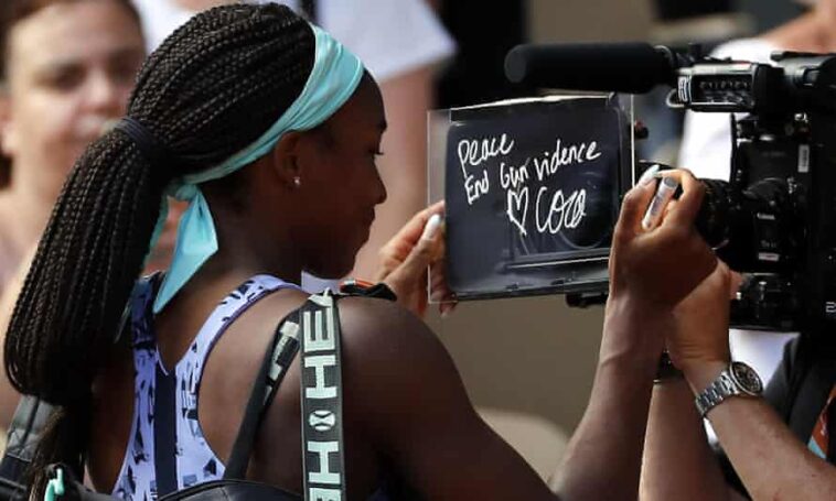 Coco Gauff writes “Peace. End gun violence” on the camera after winning against Martina Trevisan