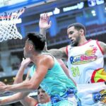 Javee Mocon of Phoenix (left) slithers past Nick Demusis for a reverse layup in the second half of a tight win for the Fuel Masters. —PHOTOS FROM PBA IMAGES