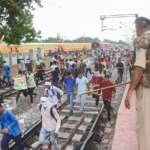 Youngsters being chased away by police personnel during their protest against governments newly introduced Agnipath scheme, at Birlanagar Junction railway station, in Gwalior (Photo: PTI)