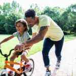 Father teaching son to ride a bicycle