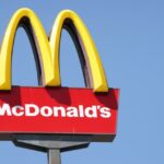 Close-up McDonalds outdoor sign against blue sky