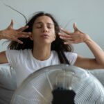 Woman in front of fan