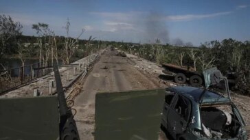 Members of a foreign volunteers unit which fights in the Ukrainian army drive on a military vehicle, as Russia