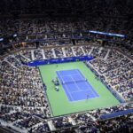 (FILES) In this file photo taken on August 31, 2021 an overview shows Arthur Ashe Stadium during the 2021 US Open Tennis tournament men's singles first round match between Serbia's Novak Djokovic (bottom) and Denmark's Holger Rune at the USTA Billie Jean King National Tennis Center in New York. - Players from Russia and Belarus will be allowed to compete in the 2022 US Open, but only under a neutral flag, the US Tennis Association announced June 14, 2022. (Photo by ANGELA  WEISS / AFP)