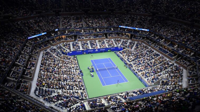 (FILES) In this file photo taken on August 31, 2021 an overview shows Arthur Ashe Stadium during the 2021 US Open Tennis tournament men's singles first round match between Serbia's Novak Djokovic (bottom) and Denmark's Holger Rune at the USTA Billie Jean King National Tennis Center in New York. - Players from Russia and Belarus will be allowed to compete in the 2022 US Open, but only under a neutral flag, the US Tennis Association announced June 14, 2022. (Photo by ANGELA  WEISS / AFP)