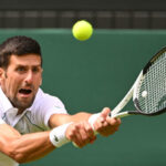 Serbia's Novak Djokovic returns the ball to Australia's Thanasi Kokkinakis during their men's singles tennis match on the third day of the 2022 Wimbledon Championships at The All England Tennis Club in Wimbledon, southwest London, on June 29, 2022. (Photo by SEBASTIEN BOZON / AFP) / RESTRICTED TO EDITORIAL USE