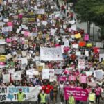 THOUSANDS march through the US in protest of abortion law