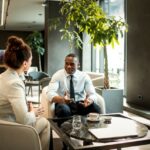 Business colleagues having coffee in a hotel lobby