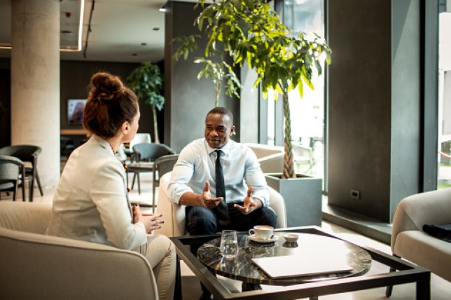 Business colleagues having coffee in a hotel lobby