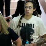 WNBA star and two-time Olympic gold medalist Brittney Griner is escorted to a courtroom for a hearing, in Khimki just outside Moscow, Russia, Friday, July 1, 2022. U.S. basketball star Brittney Griner is set to go on trial in a Moscow-area court Friday. The proceedings that are scheduled to begin Friday come about 4 1/2 months after she was arrested on cannabis possession charges at an airport while traveling to play for a Russian team. (AP Photo/Alexander Zemlianichenko)