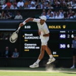 Serbia's Novak Djokovic serves against Britain's Cameron Norrie during their men's singles semi final tennis match on the twelfth day of the 2022 Wimbledon Championships at The All England Tennis Club in Wimbledon, southwest London, on July 8, 2022. (Photo by Adrian DENNIS / AFP) / RESTRICTED TO EDITORIAL USE