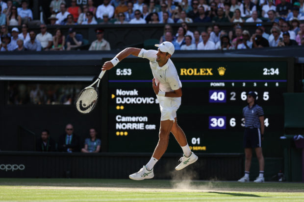 Serbia's Novak Djokovic serves against Britain's Cameron Norrie during their men's singles semi final tennis match on the twelfth day of the 2022 Wimbledon Championships at The All England Tennis Club in Wimbledon, southwest London, on July 8, 2022. (Photo by Adrian DENNIS / AFP) / RESTRICTED TO EDITORIAL USE