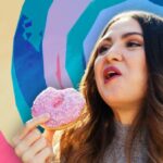 woman eating a doughnut with mouth open