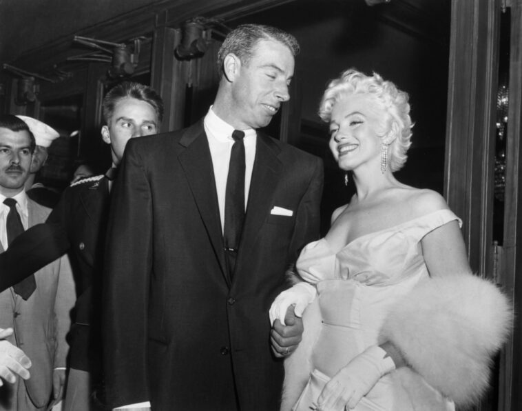 Joe DiMaggio escorts ex-wife Marilyn Monroe to the premiere of her movie The Seven Year Itch