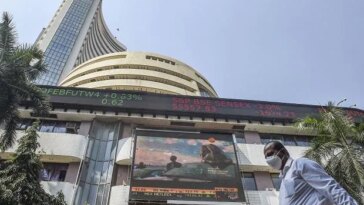 People walk past the Bombay Stock Exchange (BSE) building, in Mumbai (Photo: PTI)