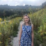 Lilith Hudson standing in a field of flowers