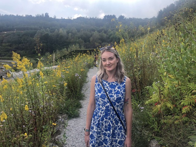 Lilith Hudson standing in a field of flowers