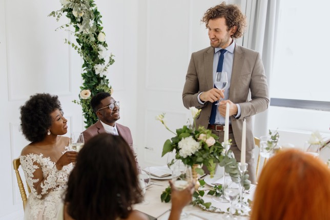 Best man giving a toast and speech at a wedding reception