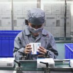 BEIJING, CHINA - MARCH 13: An employee works on the production line of Lianhuaqingwen granules, a compound herbal medicine for treating the common cold and influenza virus, at Beijing Yiling Pharmaceutical Co., Ltd on March 13, 2020 in Beijing, China. (Photo by Cui Nan/China News Service via Getty Images)