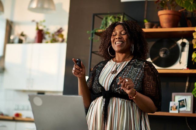 Mid adult woman giving online presentation from home