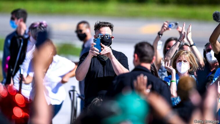 SpaceX CEO Elon Musk takes photos with his phone during the Inspiration4 crew send off at NASAs Kennedy Space Center in Florida, on September 15, 2021. - SpaceX is preparing to send the first all-civilian crew into Earth orbit on the evening of September 15, capping a summer of private spaceflight with one of the most ambitious tourism missions to date. (Photo by CHANDAN KHANNA / AFP) (Photo by CHANDAN KHANNA/AFP via Getty Images)