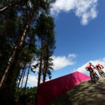 Two cyclists traveling through Cannock Chase for the Commonwealth Games time trial