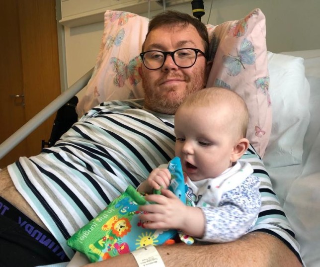 Jim Fisher with his baby in hospital