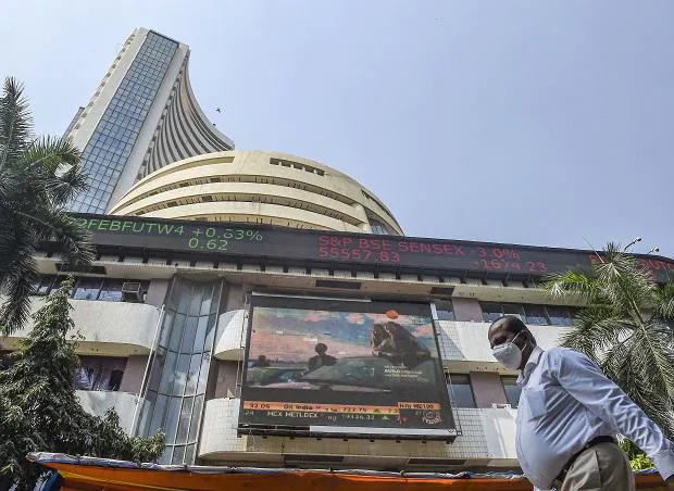 People walk past the Bombay Stock Exchange (BSE) building, in Mumbai (Photo: PTI)