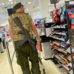 A Ukrainian serviceman pushes a trolley inside a supermarket in Kharkiv.