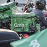 A GrabFood delivery rider in Singapore, on Wednesday, May 18, 2022. Grab Holdings Ltd., is expected to report results on May 19. Photographer: Bryan van der Beek/Bloomberg via Getty Images