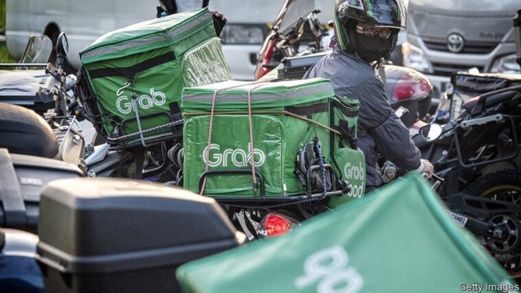 A GrabFood delivery rider in Singapore, on Wednesday, May 18, 2022. Grab Holdings Ltd., is expected to report results on May 19. Photographer: Bryan van der Beek/Bloomberg via Getty Images