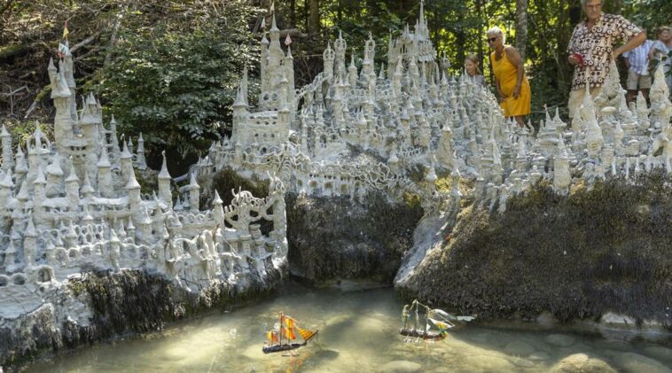 Swiss artist sculpts sprawling model castle on dried river bank