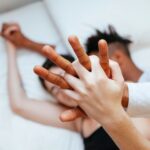 Couple holding hands in bed