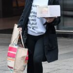 Out and about: Coleen Rooney cut a casual figure in a empowerment logo jumper as she stepped out in Cheshire on Friday