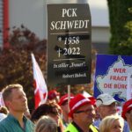 SCHWEDT, GERMANY - JUNE 29: People, including workers from the nearby PCK oil refinery, gather to demand an end to the current, planned German embargo against the import of Russian oil on June 29, 2022 in Schwedt, Germany. Schwedt relies heavily on the jobs at the PCK refinery, and many worry for their economic future since the refinery receives its crude oil exclusively from Russia via the "Friendship" ("Druzhba") pipeline. Germany plans to end its imports of Russian oil within the near future due to Russia's ongoing war in Ukraine and is also seeking to possibly nationalize the refinery, which is currently majority-owned by Russian energy company Rosneft. (Photo by Omer Messinger/Getty Images)