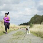 Woman running with dog