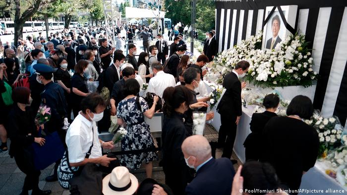 People gather to mourn Japan's former Prime Minister Shinzo Abe near Nippon Budokan in Chiyoda Ward, Tokyo on September 27, 2022, the day of his state funeral.