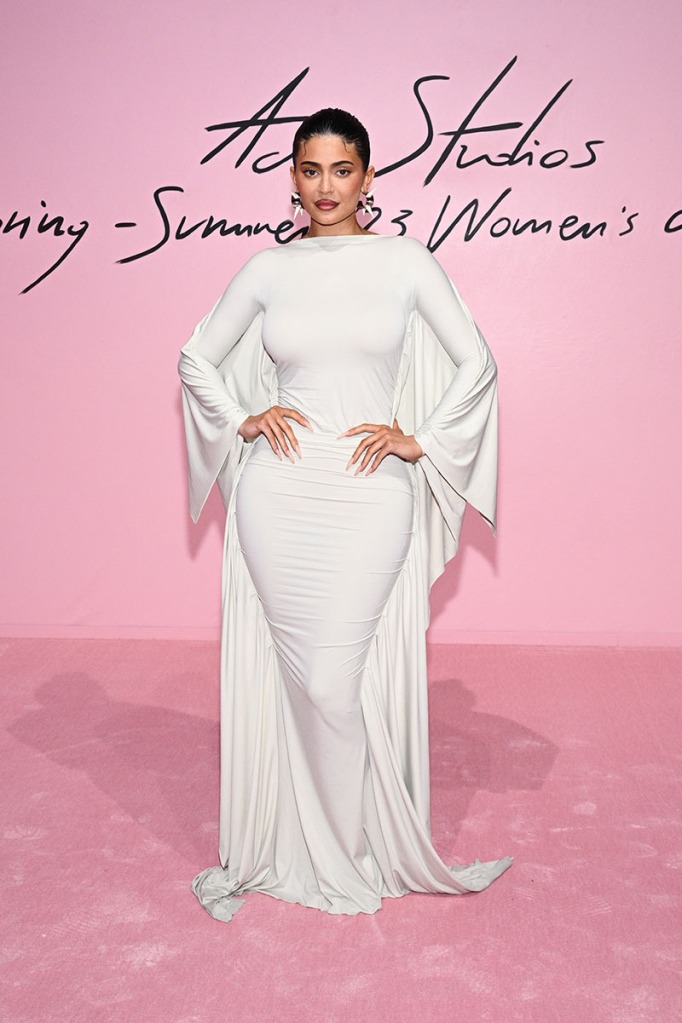 Kylie Jenner Makes an Ethereal Arrival in White Cape Dress for Acne Studios’ Paris Fashion Week Spring 2023 Show