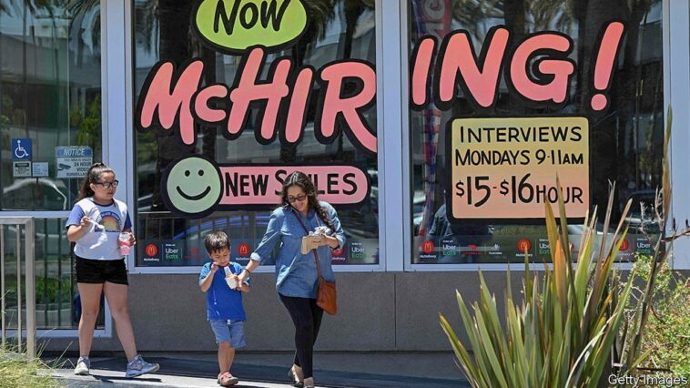 (FILES) In this file photo taken on July 08, 2022, a family walks past a "Hiring" sign at a McDonald's restaurant in Garden Grove, California. - US employers slowed the pace of hiring in August after the surprising surge in the prior month and the jobless rate edged up, the government reported on September 2, 2022. Even with the slowing pace, the job gains bring employment above the pre-pandemic level, the Labor Department said. US employment increased by 315,000 jobs last month, the report said, which was in line with what economists were expecting after the 526,000 hires in July. (Photo by Robyn BECK / AFP) (Photo by ROBYN BECK/AFP via Getty Images)