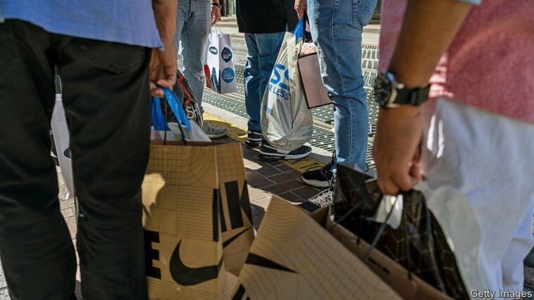 Shoppers carry bags in San Francisco, California, US, on Thursday, Sept. 29, 2022. US consumer confidence rose for a second month in September to the highest since April, indicating a strong job market and lower gas prices are contributing to more optimistic views of the economy. Photographer: David Paul Morris/Bloomberg via Getty Images