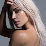 Flawless: Kim Kardashian went topless as she showed off her flawless complexion while advertising her SKKN skincare line on Saturday