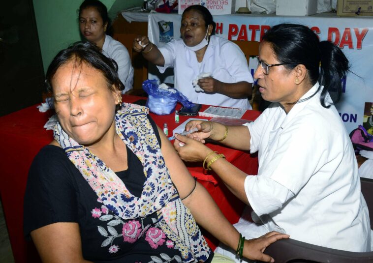 A healthcare worker administers a booster dose of COVID-19 vaccine to a beneficiary, in Guwahati.