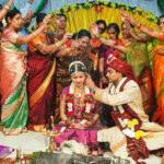 BYCEJW Guests throw rice grains over a newly married couple to symbolize abundance and good fortune at a Hindu wedding in India